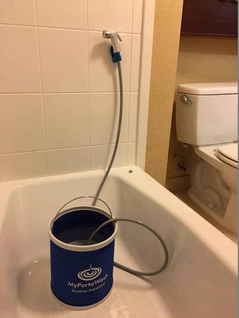 bidet hose sitting in a bucket of water