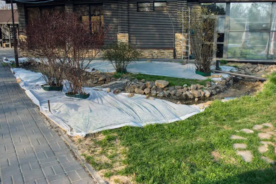 white burlap sheets are used to cover grass seeds